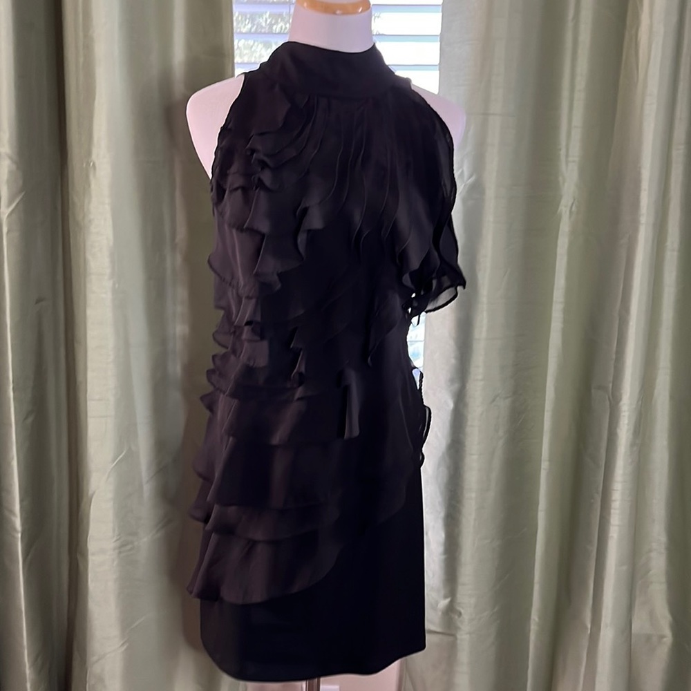 Black sleeveless dress with ruffles and high collar